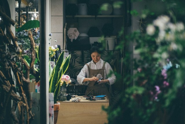 Small business owner working at a shop counter