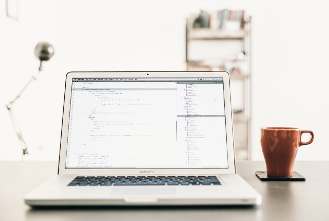 Laptop open on a desk with a web browser window